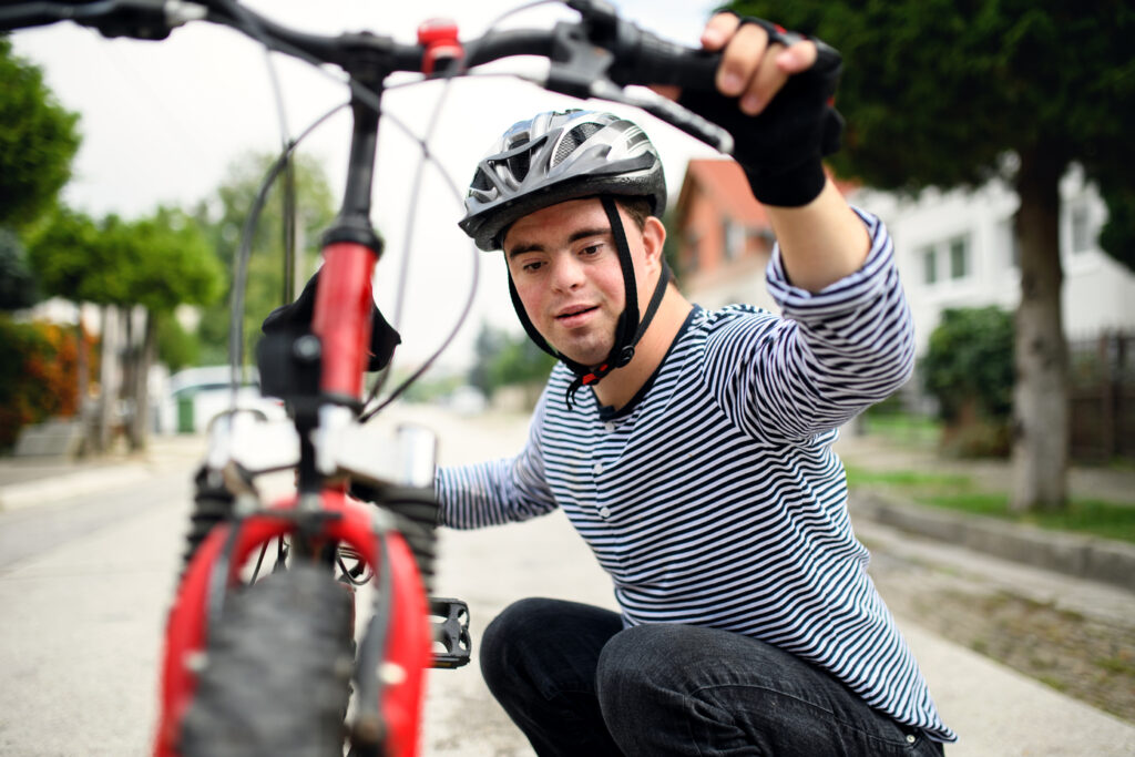 Man with Down syndrome fixing his bike